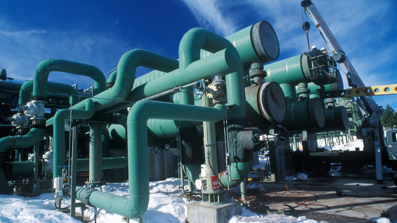 Industrial geothermal heat pump piping and valves supporting building heating systems