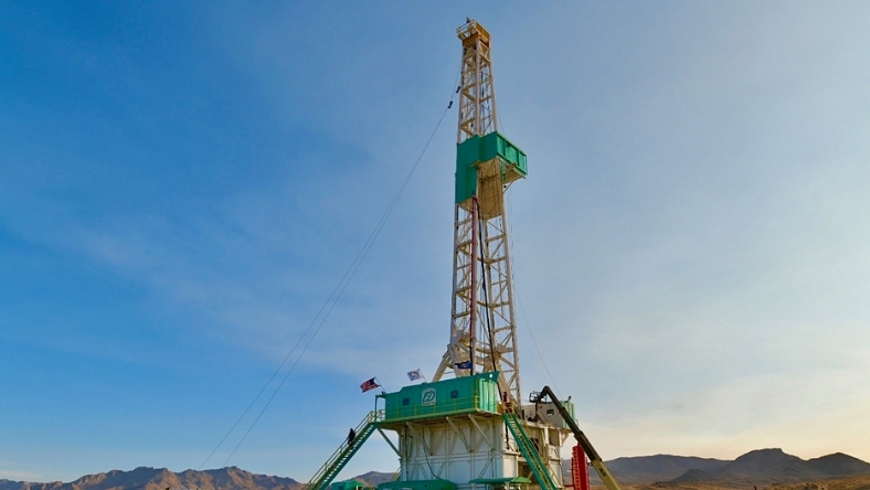 Onshore geothermal drilling rig operating in desert landscape